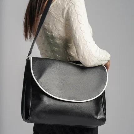 Trendy-Woman-Carrying-Jia-Flap-Bag-Black-Closeup-View-Cahlah
